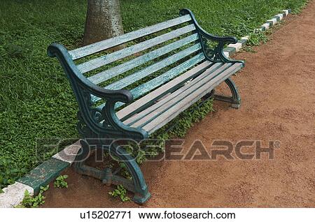 Stock Image - Bench in a botanical garden, Lal Bagh Botanical Garden, Bangalore, Karnataka, India. Fotosearch