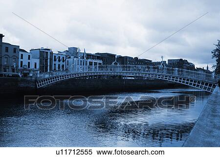 Stock Photography - Bridge across a river, Ha'penny Bridge, Liffey River, Dublin, Republic of Ireland. Fotosearch