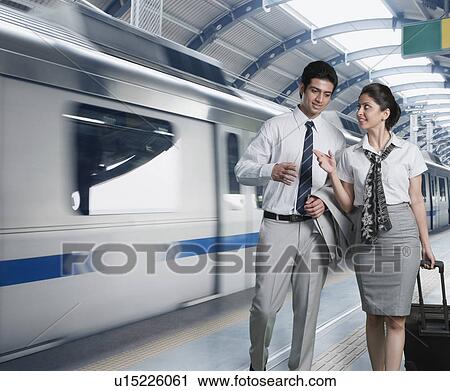 Stock Image - Business couple at a subway station. Fotosearch