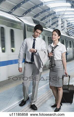 Stock Photo - Business couple at a subway station. Fotosearch