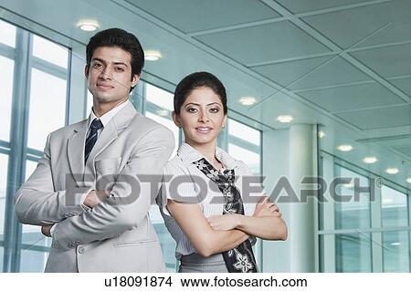 Picture - Business couple at an airport lounge. Fotosearch