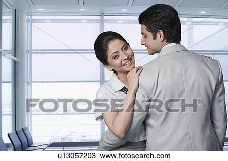 Stock Image - Business couple at an airport lounge. Fotosearch