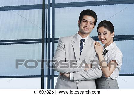 Stock Image - Business couple at an airport lounge. Fotosearch