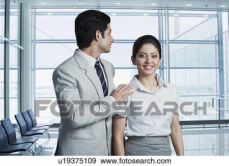 Business couple at an airport lounge View Large Photo Image Stock Photo - Business couple at an airport lounge. Fotosearch