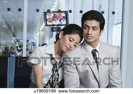 Stock Photo - Business couple at an airport lounge. Fotosearch