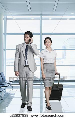 Business couple at an airport lounge View Large Photo Image Stock Photo - Business couple at an airport lounge. Fotosearch