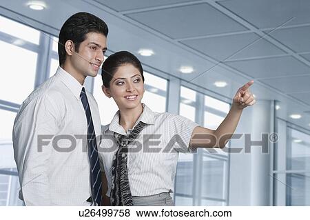 Stock Photo - Business couple at an airport lounge. Fotosearch