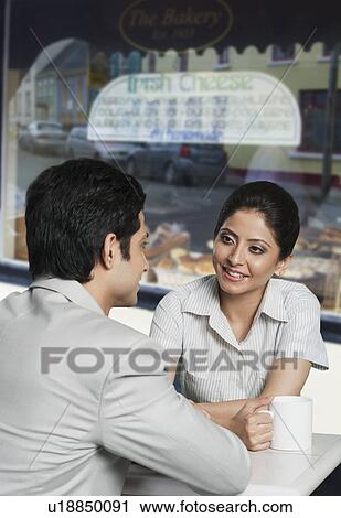 Stock Image - Business couple in a coffee shop. Fotosearch