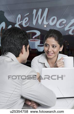 Business couple in a coffee shop View Large Photo Image Stock Photo - Business couple in a coffee shop. Fotosearch