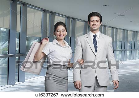 Stock Photo - Business couple in a shopping mall. Fotosearch