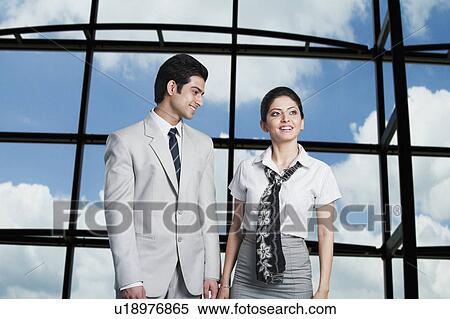 Business couple standing at an airport lounge View Large Photo Image Stock Photography - Business couple standing at an airport lounge. Fotosearch