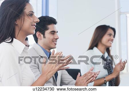 Business executives applauding at a meeting View Large Photo Image Stock Image - Business executives applauding at a meeting. Fotosearch