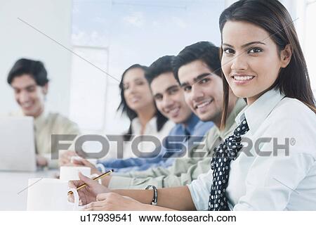 Stock Image - Business executives in a meeting. Fotosearch