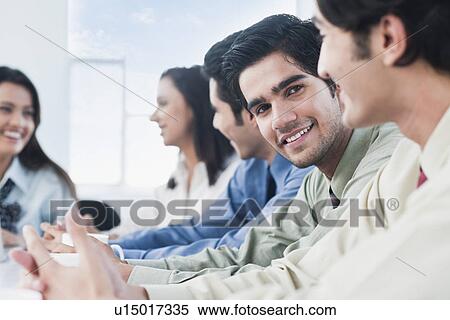 Stock Photography - Business executives in a meeting. Fotosearch