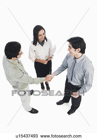 Stock Image - Business executives shaking hands. Fotosearch