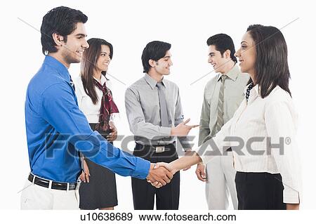 Stock Photo - Business executives shaking hands. Fotosearch