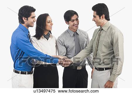 Stock Photography - Business executives stacking hands. Fotosearch