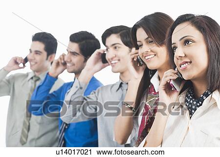 Stock Image - Business executives talking on mobile phones. Fotosearch