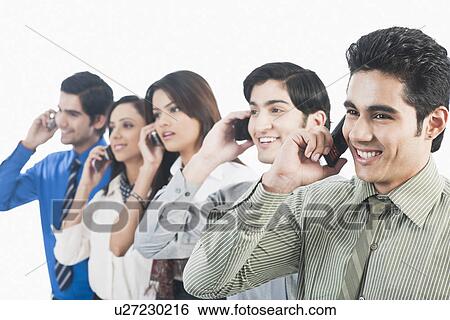 Business executives talking on mobile phones View Large Photo Image Stock Photograph - Business executives talking on mobile phones. Fotosearch