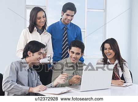 Stock Photo - Business executives working in an office. Fotosearch