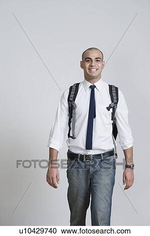 Businessman carrying a backpack and smiling View Large Photo Image Stock Image - Businessman carrying a backpack and smiling. Fotosearch