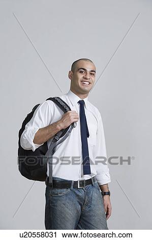 Businessman carrying a backpack and smiling View Large Photo Image Stock Image - Businessman carrying a backpack and smiling. Fotosearch
