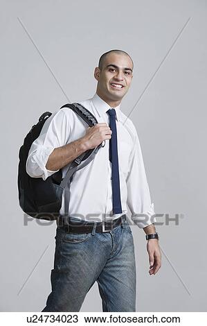 Businessman carrying a backpack and smiling View Large Photo Image Stock Image - Businessman carrying a backpack and smiling. Fotosearch