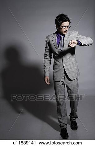 Businessman checking the time View Large Photo Image Stock Image - Businessman checking the time. Fotosearch