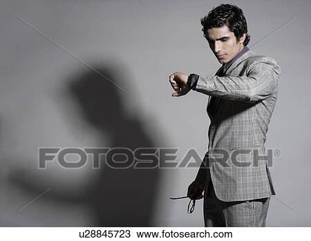 Businessman checking the time View Large Photo Image Stock Image - Businessman checking the time. Fotosearch