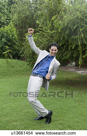 Businessman dancing in the rain View Large Photo Image Picture - Businessman dancing in the rain. Fotosearch