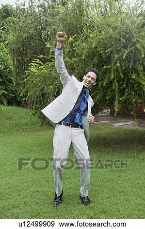 Stock Photo - Businessman dancing in the rain. Fotosearch