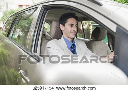 Businessman driving a car View Large Photo Image Picture - Businessman driving a car. Fotosearch