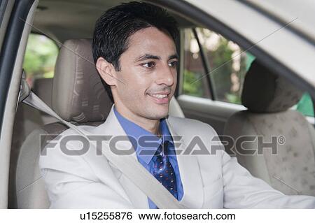 Businessman driving a car View Large Photo Image Stock Photograph - Businessman driving a car. Fotosearch