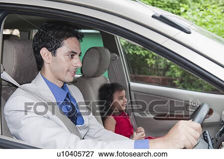 Businessman driving a car with his daughter View Large Photo Image Stock Photo - Businessman driving a car with his daughter. Fotosearch