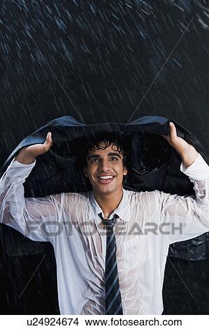 Businessman enjoying in the rain View Large Photo Image Picture - Businessman enjoying in the rain. Fotosearch