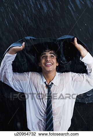 Businessman enjoying in the rain View Large Photo Image Stock Image - Businessman enjoying in the rain. Fotosearch