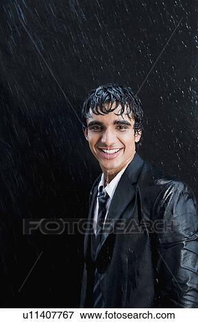 Businessman enjoying in the rain View Large Photo Image Stock Photo - Businessman enjoying in the rain. Fotosearch