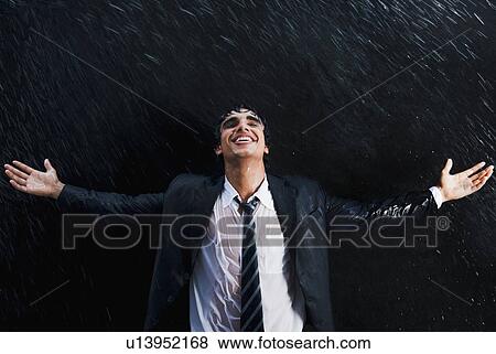 Stock Photo - Businessman enjoying in the rain. Fotosearch