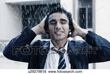 Businessman enjoying in the rain View Large Photo Image Stock Photo - Businessman enjoying in the rain. Fotosearch