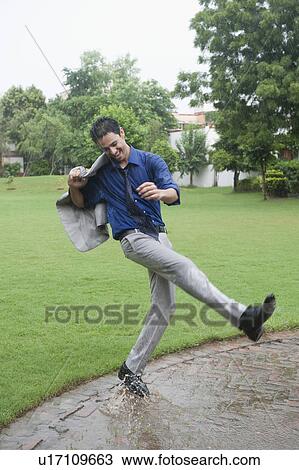 Businessman enjoying rain View Large Photo Image Stock Image - Businessman enjoying rain. Fotosearch