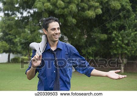Businessman enjoying rain View Large Photo Image Stock Image - Businessman enjoying rain. Fotosearch