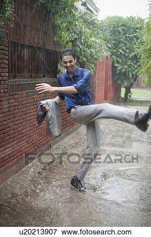 Stock Photo - Businessman enjoying rain. Fotosearch