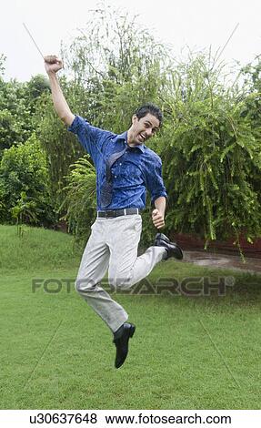 Stock Photo - Businessman enjoying rain. Fotosearch