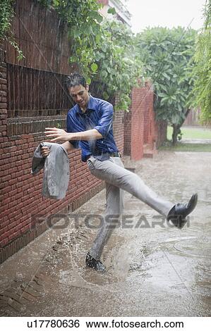 Businessman enjoying rain View Large Photo Image Stock Photograph - Businessman enjoying rain. Fotosearch