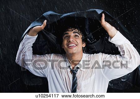 Businessman enjoying the rain View Large Photo Image Stock Photo - Businessman enjoying the rain. Fotosearch