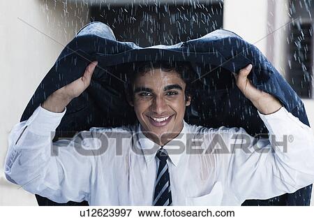 Stock Photo - Businessman enjoying the rain. Fotosearch