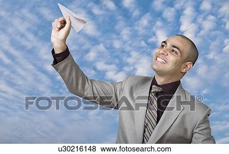 Businessman flying a paper plane View Large Photo Image Stock Photo - Businessman flying a paper plane. Fotosearch