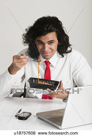 Businessman frowning at a bowl of noodles View Large Photo Image Stock Photo - Businessman frowning at a bowl of noodles. Fotosearch