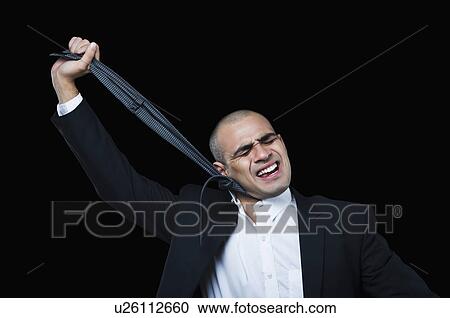 Businessman hanging himself with his tie View Large Photo Image Stock Image - Businessman hanging himself with his tie. Fotosearch
