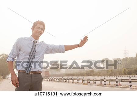 Businessman hitchhiking, Gurgaon, Haryana, India View Large Photo Image Stock Image - Businessman hitchhiking, Gurgaon, Haryana, India. Fotosearch